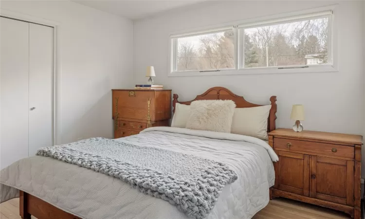 Bedroom featuring light wood-type flooring and a closet