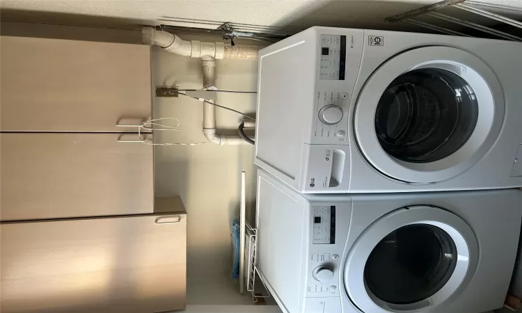 Laundry room featuring cabinets and washing machine and clothes dryer