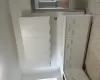 Kitchen with sink, white cabinetry, and light tile patterned floors