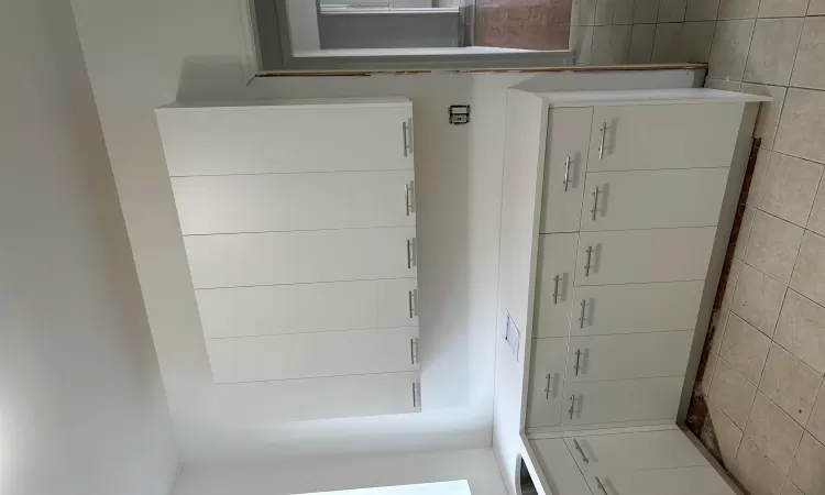 Kitchen with sink, white cabinetry, and light tile patterned floors