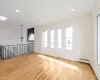 Spare room featuring a healthy amount of sunlight, a skylight, baseboard heating, and light hardwood / wood-style flooring