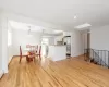 Dining area with light wood-type flooring and a skylight