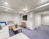 Living room with dark carpet and a baseboard radiator