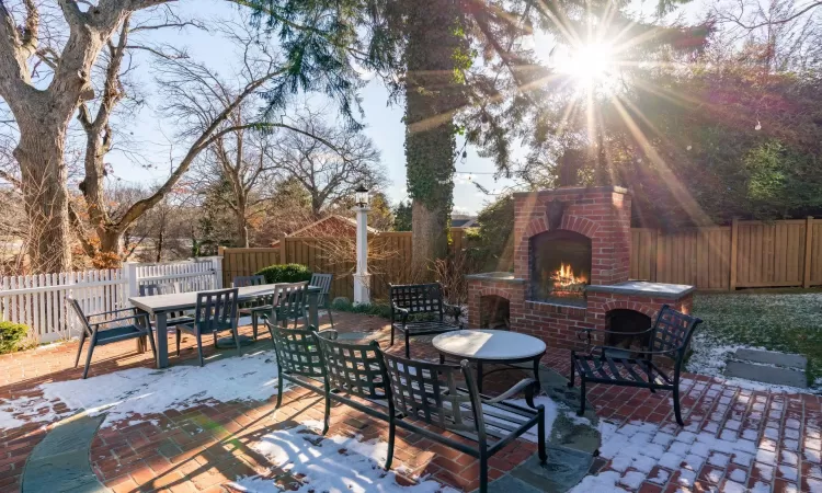 View of patio featuring an outdoor brick fireplace