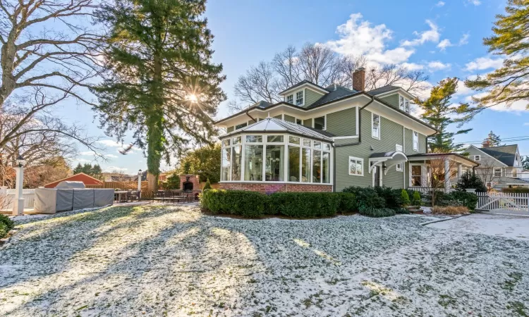 Back of property featuring a sunroom