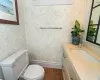 Bathroom featuring toilet, vanity, and tile patterned flooring