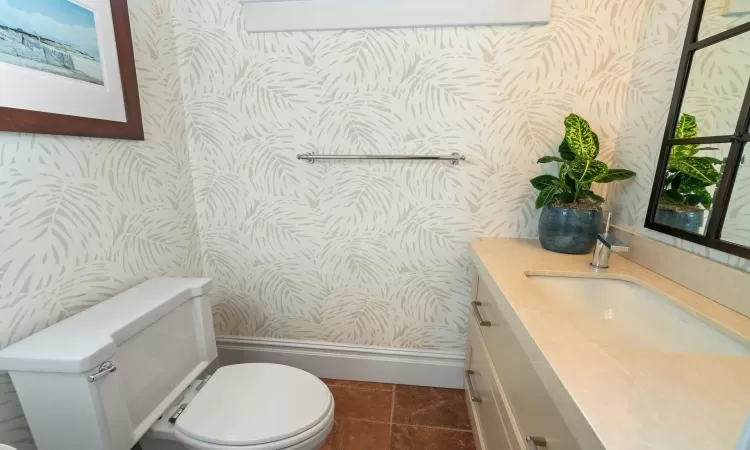 Bathroom featuring toilet, vanity, and tile patterned flooring