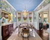 Dining area featuring ornamental molding, a chandelier, and dark parquet floors