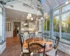 Dining area featuring ceiling fan with notable chandelier and a towering ceiling