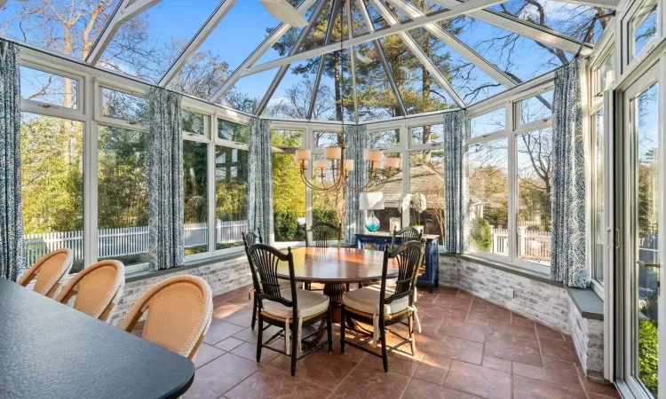 Sunroom / solarium with a notable chandelier