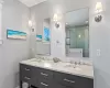 Bathroom featuring an enclosed shower and vanity