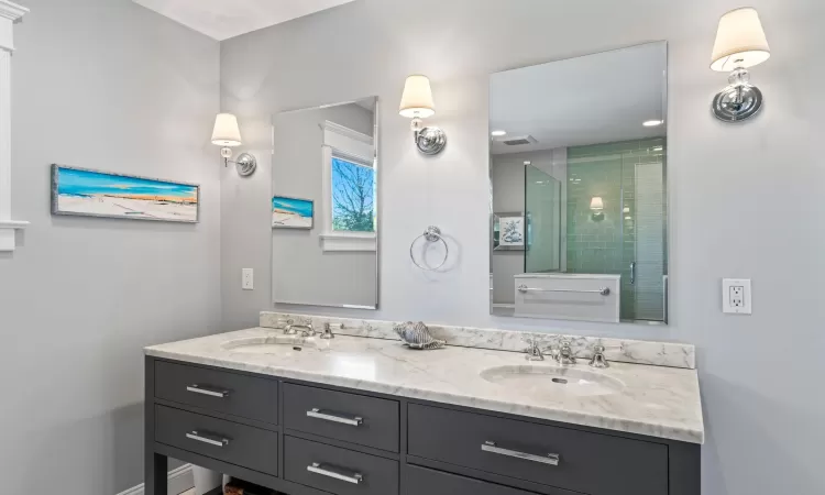 Bathroom featuring an enclosed shower and vanity