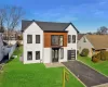 Modern farmhouse with a front lawn and a garage