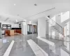 Kitchen featuring stainless steel fridge with ice dispenser, white cabinetry, a raised ceiling, and a kitchen island