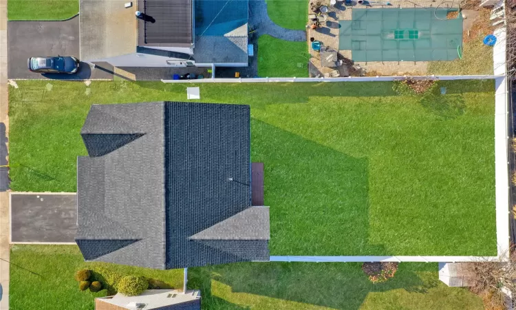 Contemporary home with a front lawn, a garage, and central AC