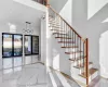 Foyer entrance featuring a towering ceiling and french doors