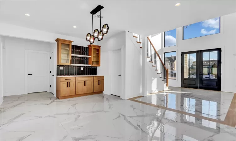 Kitchen featuring tasteful backsplash, a kitchen island, and stainless steel refrigerator