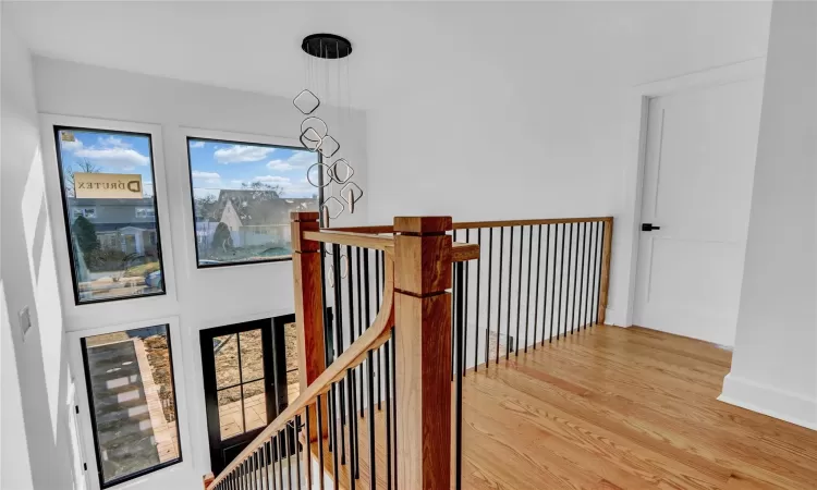 Hall with hardwood / wood-style floors