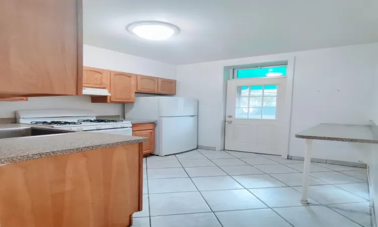 Kitchen featuring sink and white appliances