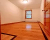 Spare room featuring light wood-type flooring and a baseboard radiator