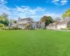 View of front of house featuring a front yard, a porch, and a garage