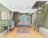 Bedroom featuring crown molding, an inviting chandelier, and hardwood / wood-style flooring