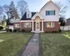 View of front of property with a front lawn and a garage