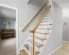 Stairway featuring ornamental molding and tile patterned flooring