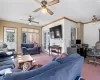 Carpeted living room featuring crown molding and brick wall