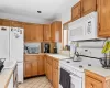 Kitchen featuring white appliances and light tile patterned floors