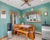 Tiled dining room featuring ceiling fan and a baseboard radiator