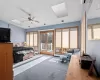 Bedroom featuring a baseboard heating unit, ceiling fan, access to exterior, and carpet