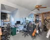 Carpeted office space featuring ceiling fan and vaulted ceiling