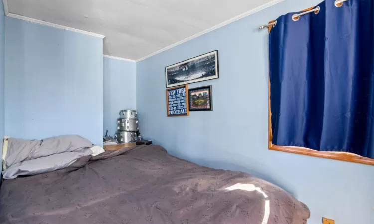 Bedroom featuring crown molding