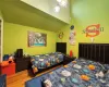 Bedroom featuring high vaulted ceiling and hardwood / wood-style floors