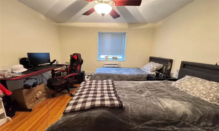 Bedroom with ceiling fan and wood-type flooring