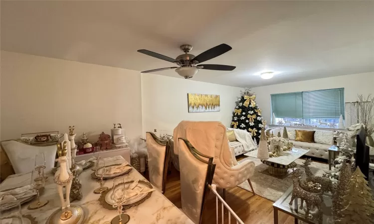 Dining space with ceiling fan and hardwood / wood-style floors