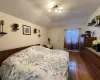 Bedroom featuring lofted ceiling, a baseboard heating unit, dark hardwood / wood-style flooring, and ceiling fan with notable chandelier