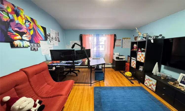 Office area featuring vaulted ceiling and hardwood / wood-style floors