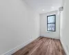 Unfurnished room featuring light wood-type flooring and a wall unit AC