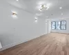 Unfurnished room featuring a chandelier and light wood-type flooring