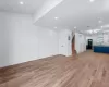 Unfurnished living room with a wall mounted AC and light wood-type flooring