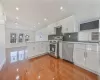 Kitchen with sink, white cabinetry, appliances with stainless steel finishes, and kitchen peninsula