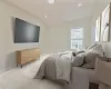 Bedroom with light carpet and vaulted ceiling