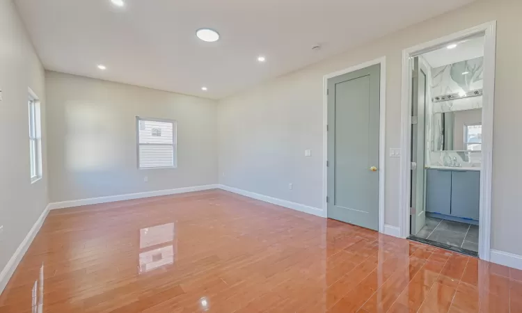 Spare room with hardwood / wood-style flooring and a healthy amount of sunlight