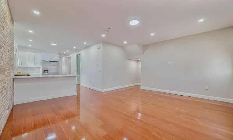 Unfurnished living room with light wood-type flooring