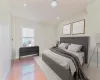 Bedroom with lofted ceiling and light hardwood / wood-style floors