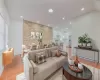 Living room featuring brick wall and light hardwood / wood-style flooring