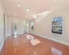 Spare room featuring plenty of natural light, wood-type flooring, and vaulted ceiling