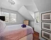 Bedroom with lofted ceiling, dark wood-type flooring, and crown molding